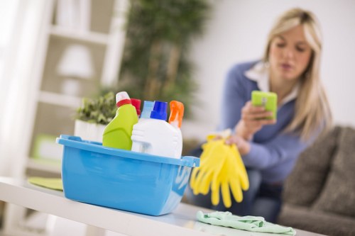 Staff member handling cleaning chemicals with protective measures